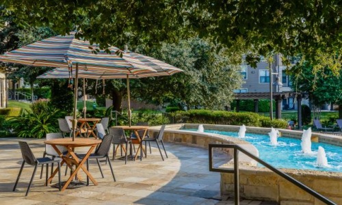 a pool with chairs and umbrellas