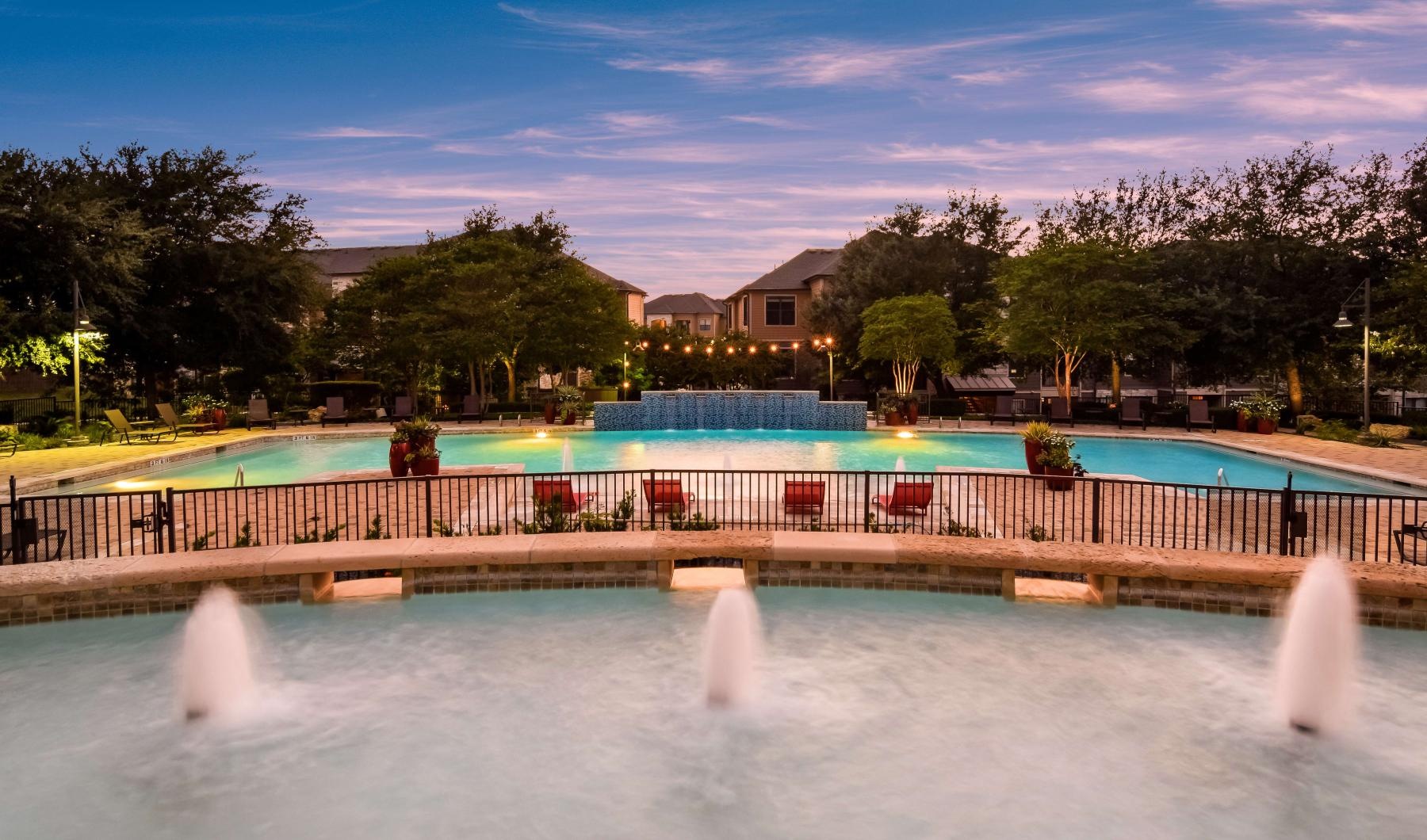 a swimming pool with a house in the background