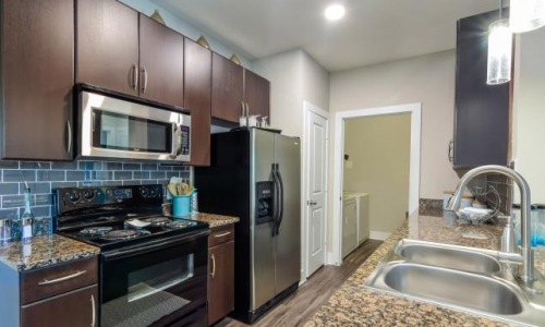 a kitchen with black appliances