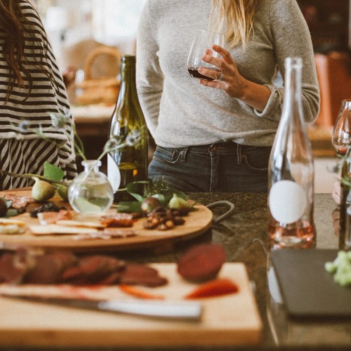 a group of women at a table with food and drinks