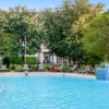 pool with water fountain and trees