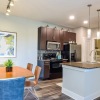 a well lit kitchen and dining room 