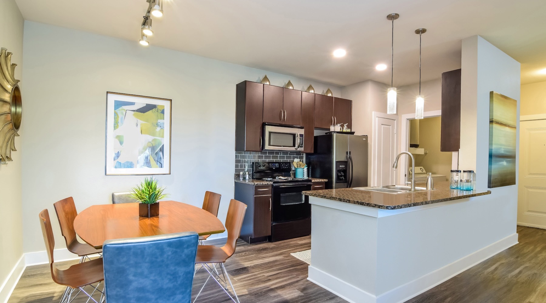 a well lit kitchen and dining room 